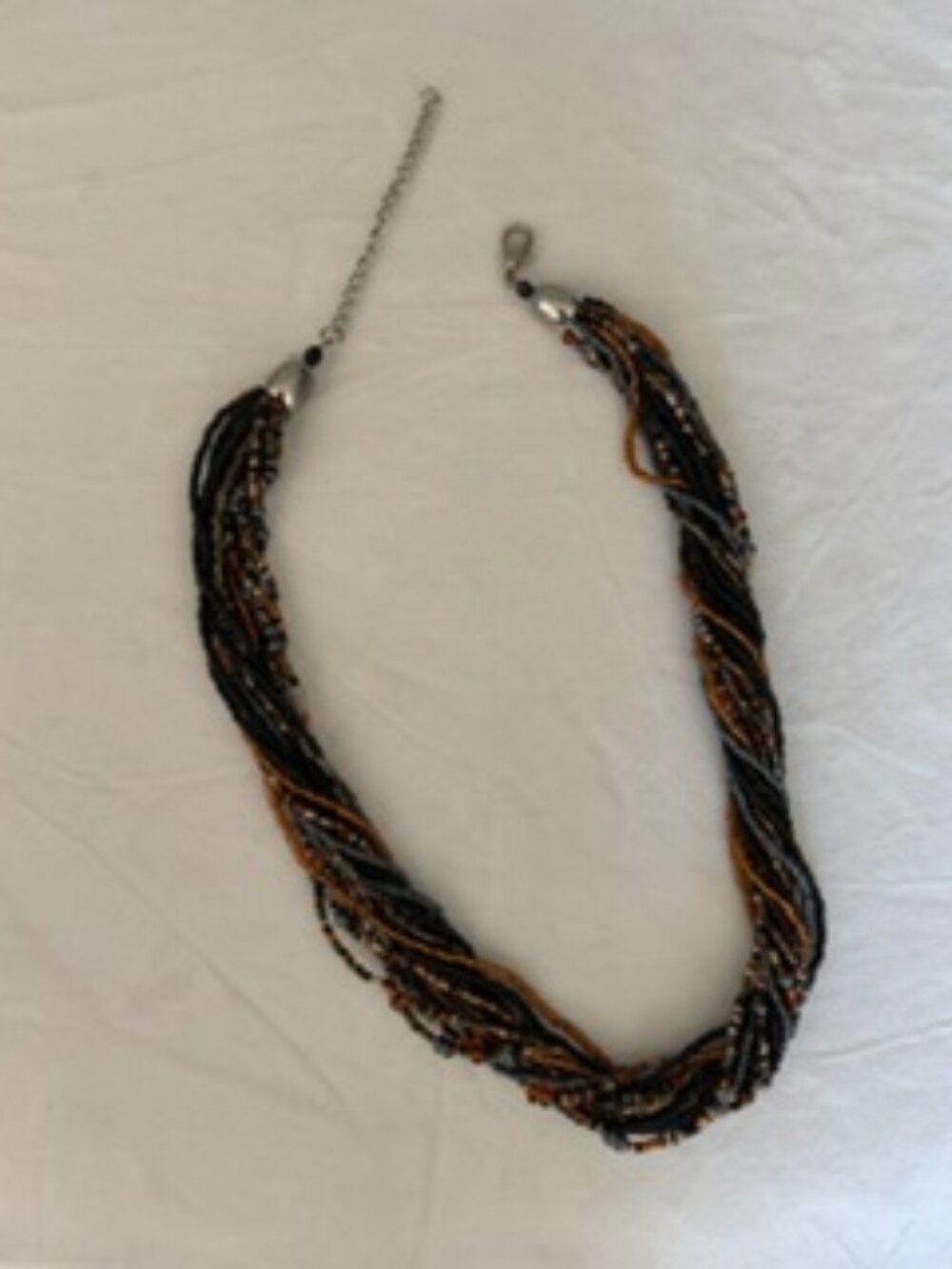 Versatile statement necklace of 15 multi-strands of fine beads.